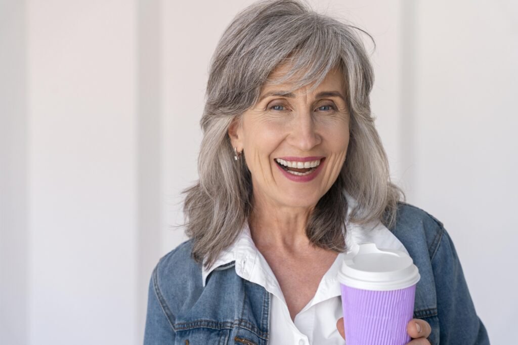How to Start Dating Again After 55 portrait smiley senior woman holding cup